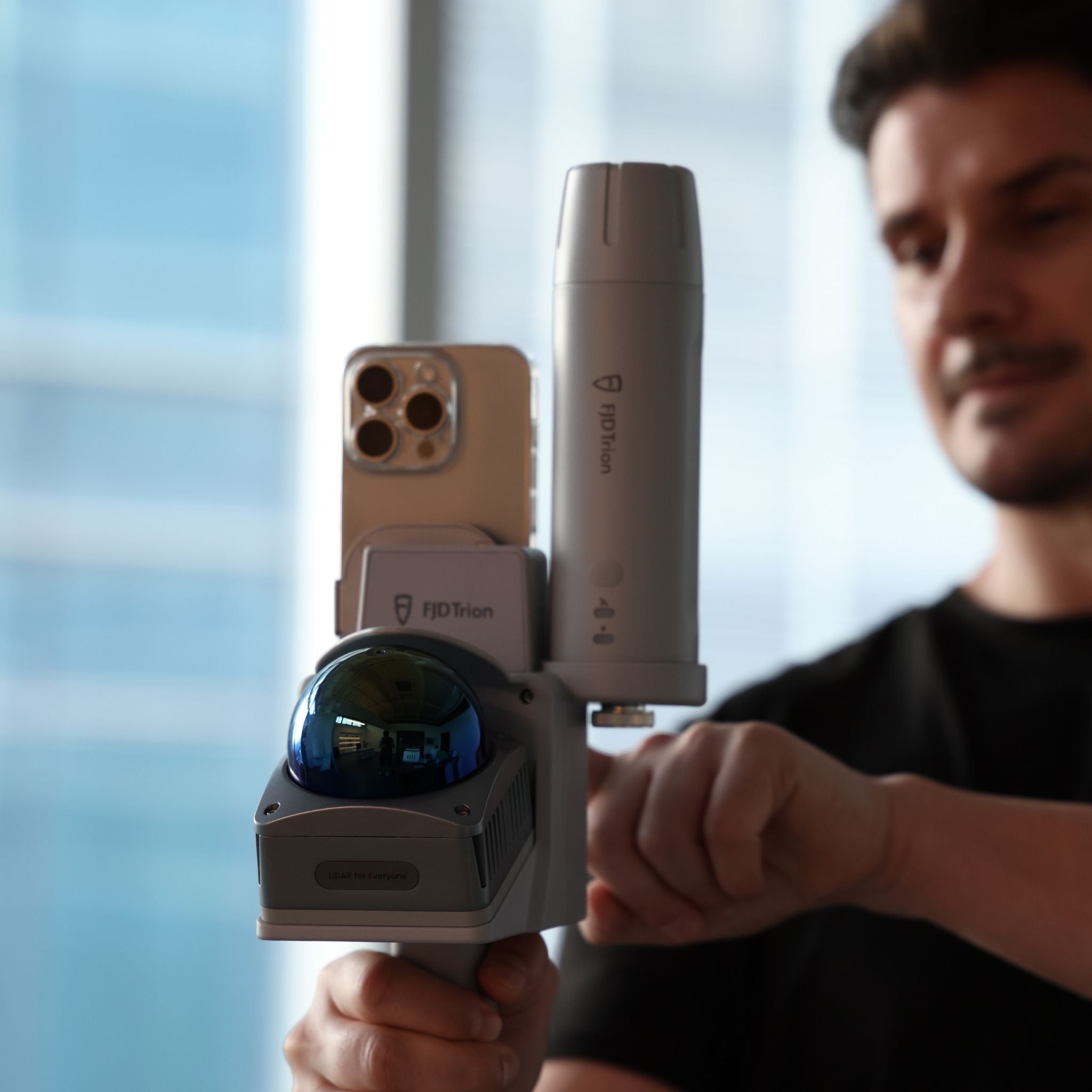 V4e Go handheld LiDAR scanner in use with a smartphone