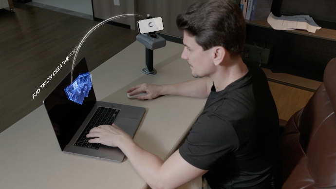 Indoor 3D scanning workflow — user reviewing generated floor plan on laptop with LiDAR scanner