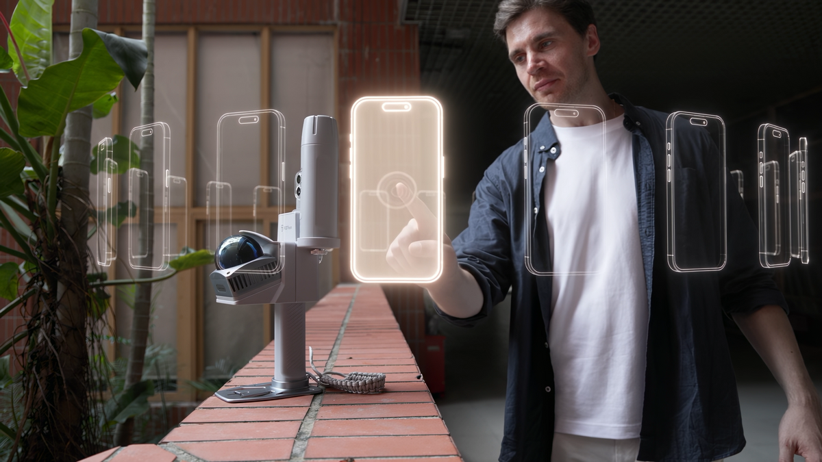 User pairing a smartphone with a handheld 3D scanner showing broad mobile phone compatibility